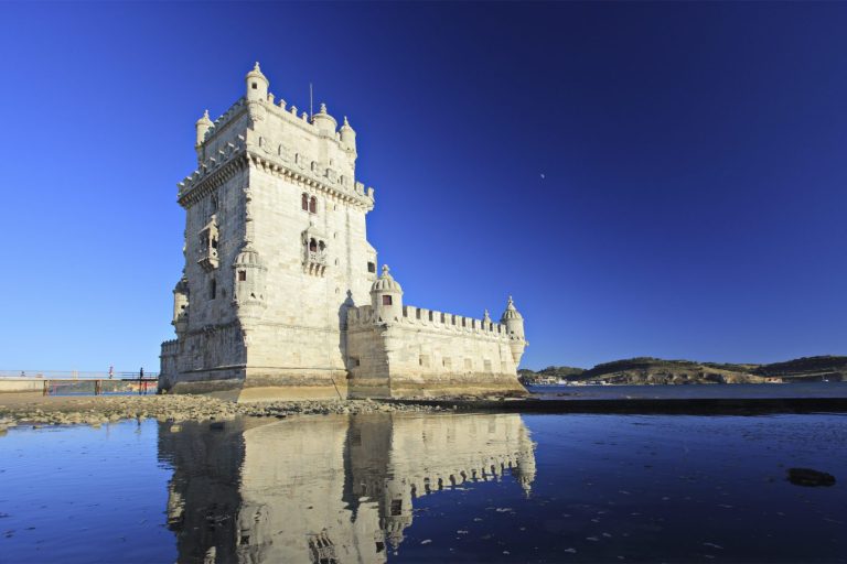 A picture of a castle against a vivid blue sky